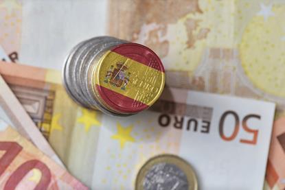 Euro coin and notes with Spanish flag