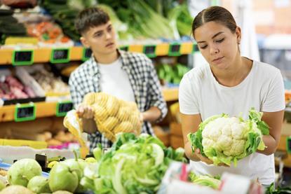 Buying vegetables in supermarket Adobe Stock