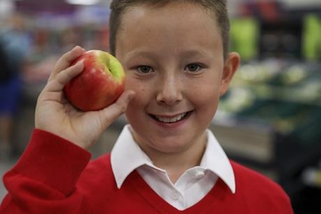 Kids are being offered free apples at Tesco to tackle holiday hunger