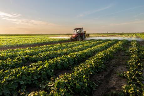 Tractor vegetable farm production input spray fertiliser pesticide AdobeStock