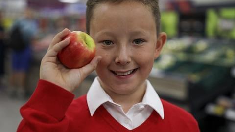 Kids are being offered free apples at Tesco to tackle holiday hunger