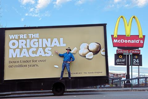 Australian macadamia nut grower Michael McMahon with the Original Macas billboard