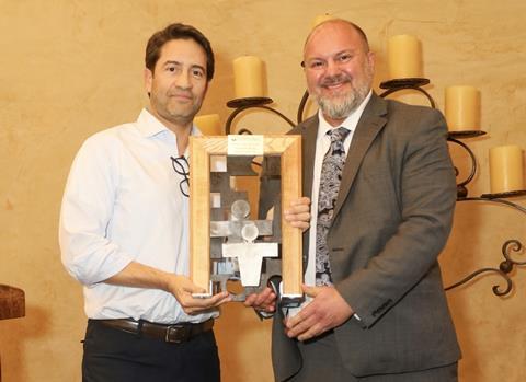 Gonzalo Avila, left, receives his award from Lance Jungmeyer
