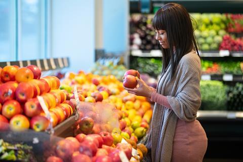Woman buying apples Adobe