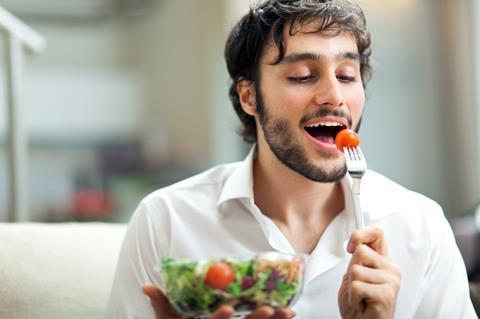 Man eating tomato salad Adobe Stock