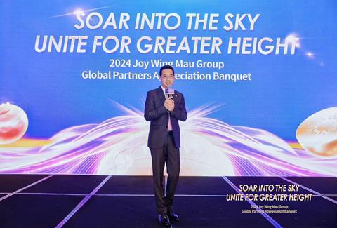 Jason Zhang, Chairman and CEO of Joy Wing Mau delivers a speech