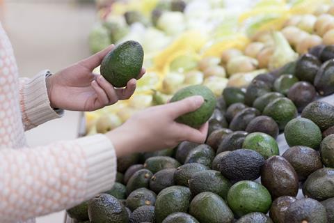 Choosing avocados in the supermarket Adobe Stock
