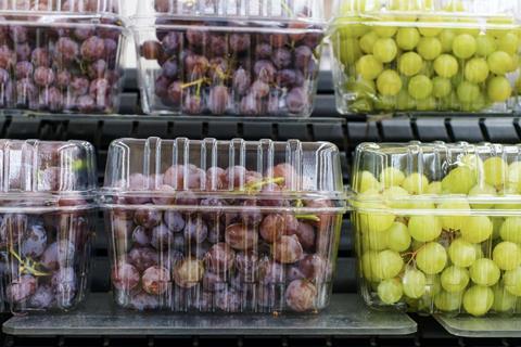 Grapes in punnets on supermarket shelves Adobe Stock