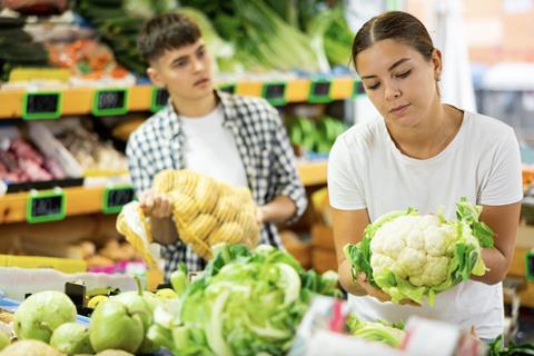 Buying vegetables in supermarket Adobe Stock